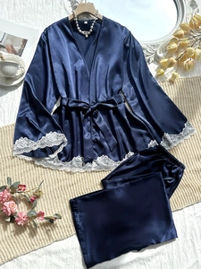 Detail of blue satin robe with white lace trim, luxury loungewear with silky finish