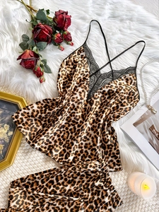 Detailed flat lay of leopard print satin sleepwear with lace trim and cross straps