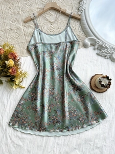 Detailed view of light green floral satin slip dress with V-neck and delicate straps