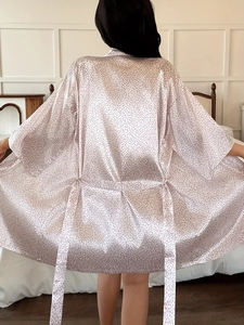 Rear view of long champagne satin bathrobe with subtle leopard print and waist belt
