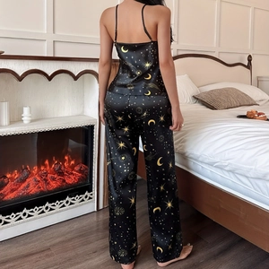 Women's black ice silk pajama set featuring celestial moon and star patterns
