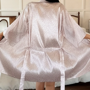 Pink polka dot three-piece women's pajama set with silky robe and matching belt