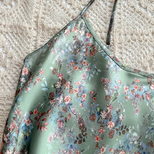 Floral print satin slip dress in sage green with red flowers and thin straps