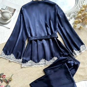 Navy blue satin pajama set with white lace trim and kimono wrap belt for lounging