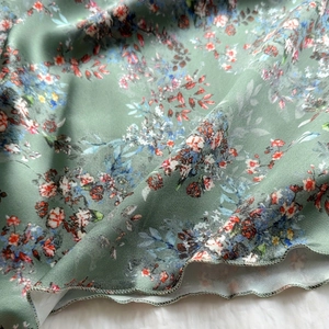 Floral print summer slip dress in sage green with ruffled hem and lightweight fabric