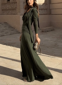 Detail view of olive green dress featuring waist pleats and an elegant halter neck tie
