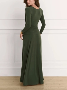 Detail of elegant dark green maxi dress featuring a high-waisted draped pleat design