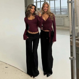 Dettaglio di un top bordeaux a maniche lunghe in maglia con bordo in pizzo e vestibilità slim