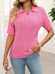 Detail of pink cable knit polo sweater with V-neck collar and high-definition texture