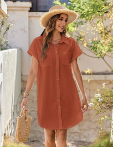 Detail of a brick red cotton linen button-down dress featuring front pockets and short sleeves