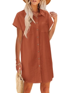 Detail view of rusty orange cotton linen dress with shirt collar and front breast pockets