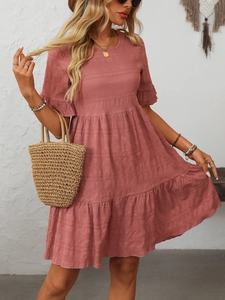 Detail of dusty pink tiered summer dress with textured seersucker fabric and ruffled sleeves