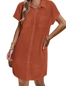 Detail of brick red cotton linen shirt dress with wooden buttons and front pockets