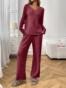 Close-up of ribbed knit wine red loungewear set with V-neck top and wide-leg trousers