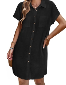 Detail view of black linen shirt dress with classic collar and wooden buttons