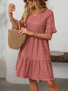 Detail of dusty rose pleated fabric with ruffled sleeves and tiered skirt texture