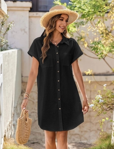 Detail of black linen shirt dress featuring wooden buttons and front chest pockets
