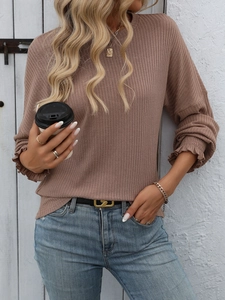 Detail of mocha brown ribbed knit shirt featuring elegant ruffled lettuce cuffs