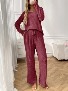 Detail of burgundy ribbed loungewear set with V-neck top and drawstring wide-leg pants