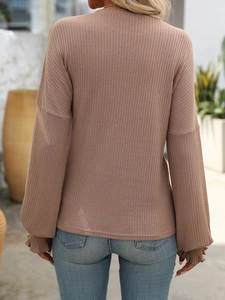 Detail of ribbed knit texture and ruffled cuffs on this dusty rose long sleeve T-shirt