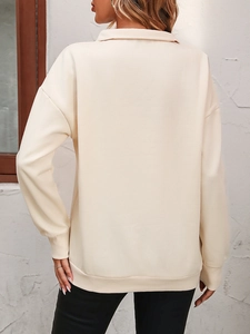 Back view of a beige drop-shoulder quarter-zip sweatshirt with ribbed cuffs and hem