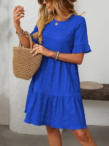 Detail of royal blue textured fabric dress with ruffled sleeves and layered tiered skirt