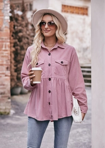 Detail of pink corduroy long sleeve babydoll shirt showing texture and ruffle hem