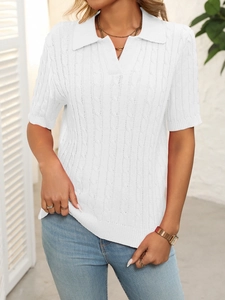 Close-up of white cable knit short sleeve polo sweater with V-neck and collar detail
