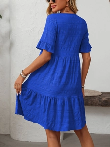 Detail of royal blue short sleeve tiered dress with shirred texture and relaxed fit