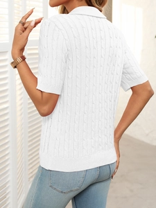 Detail of white cable knit short sleeve polo sweater with a classic turn-down collar