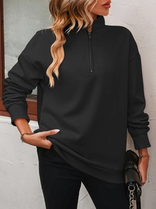 Close-up of black half-zip fleece sweatshirt with standing collar and ribbed cuffs