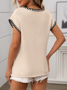 Detail of beige sleeveless knit top showing back fit and black white striped trim
