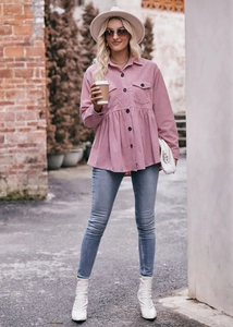 Detail view of pink corduroy babydoll shirt with peplum waist and button-up front
