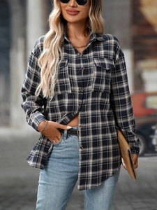 Detail of classic navy and beige plaid flannel shirt with flap pockets and wood buttons