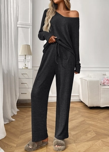 Detail of ribbed knit loungewear set showing boat neck top and wide leg pants texture