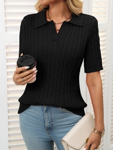 Detail of black cable knit polo sweater with V-neckline and short sleeves on model
