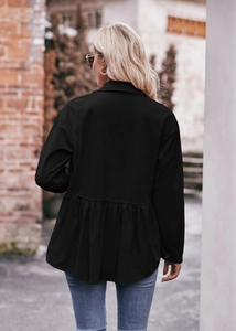 Back view of black corduroy peplum jacket with shirt collar in street style scene