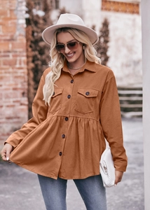 Detail of caramel corduroy shirt with pleated babydoll hem and chest flap pockets