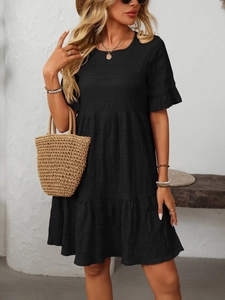 Detailed view of tiered black dress with smocking texture and ruffle short sleeves