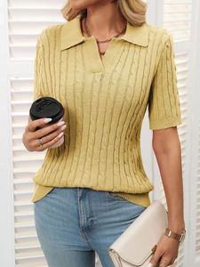 Close-up of cable knit texture on yellow short sleeve polo sweater with V-neck collar