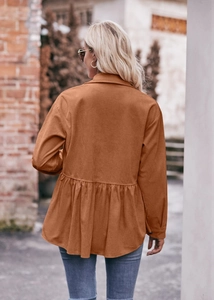 Detail of caramel corduroy babydoll top showing the pleated peplum hem and back texture