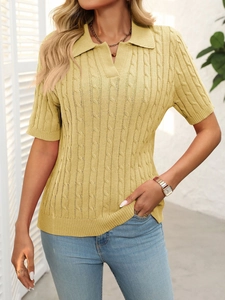 Detail of yellow cable-knit polo sweater with a V-neck collar and short sleeves texture