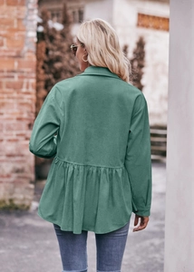 Detail of the pleated peplum hem on this dark green corduroy long sleeve shirt for women