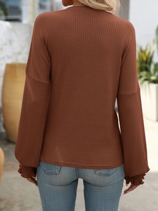 Rear view of brown ribbed knit long sleeve shirt with ruffled cuffs and drop shoulders