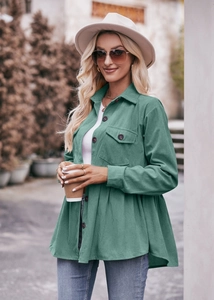 Detail of teal corduroy babydoll shirt showing the ruffled A-line hem and texture