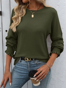 Close-up of dark green ribbed knit top featuring elegant ruffled elastic cuffs detail