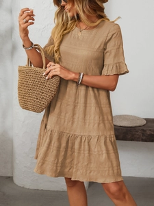 Detail of bohemian brown tiered ruffle dress with pleated texture and short sleeves