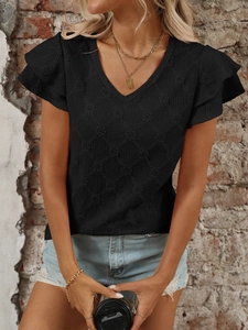 Dettaglio del top con scollo a V con maglia traforata nera e maniche a volant