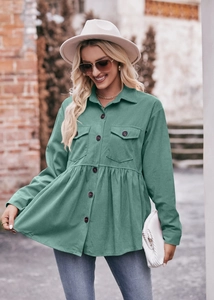 Detail of greyish-green corduroy babydoll shirt with buttons and pleated ruffle hem