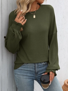 Detail of ribbed knit texture and ruffled cuffs on this olive green long sleeve top